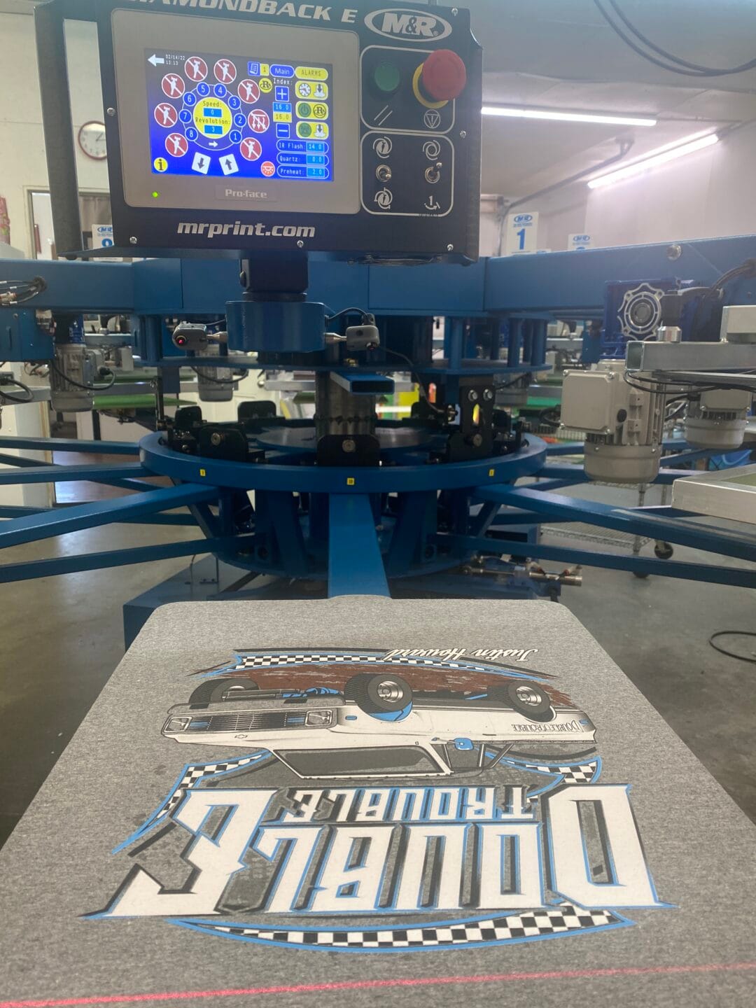 Pictured here is a close-up from the operator’s perspective on our automatic screen printing press at our screen printing facility in Joplin, MO.