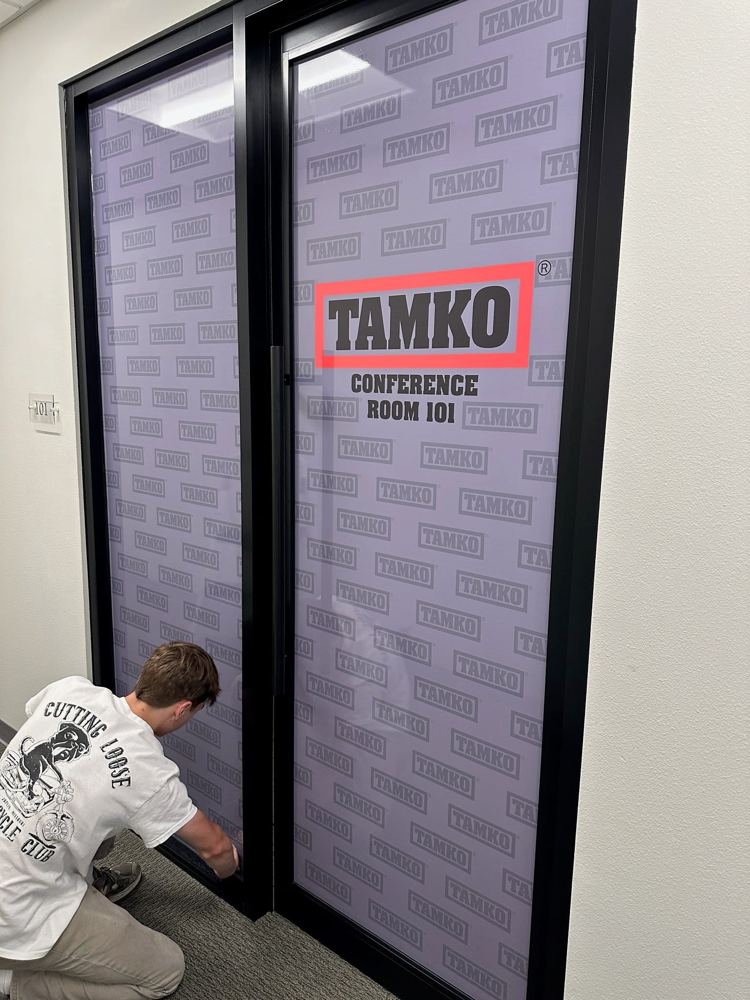 Perforated vinyl door graphic for TAMKO Building Products