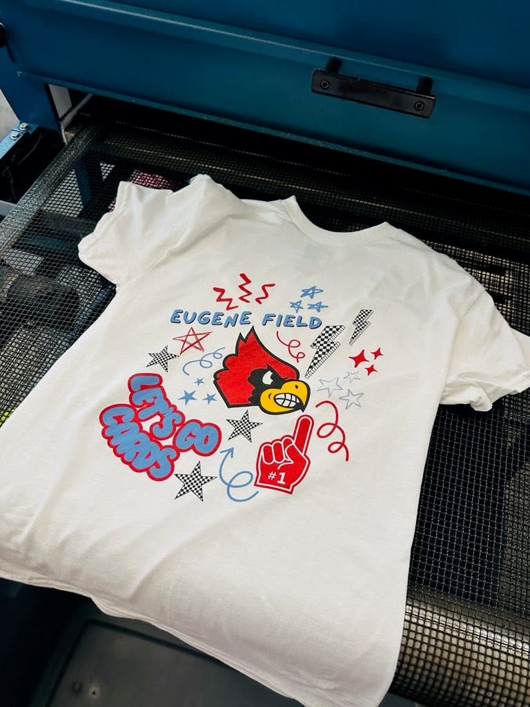 A white custom screen printed shirt for Eugene Field Elementary in Webb City, MO that says "Let's Go Cards"